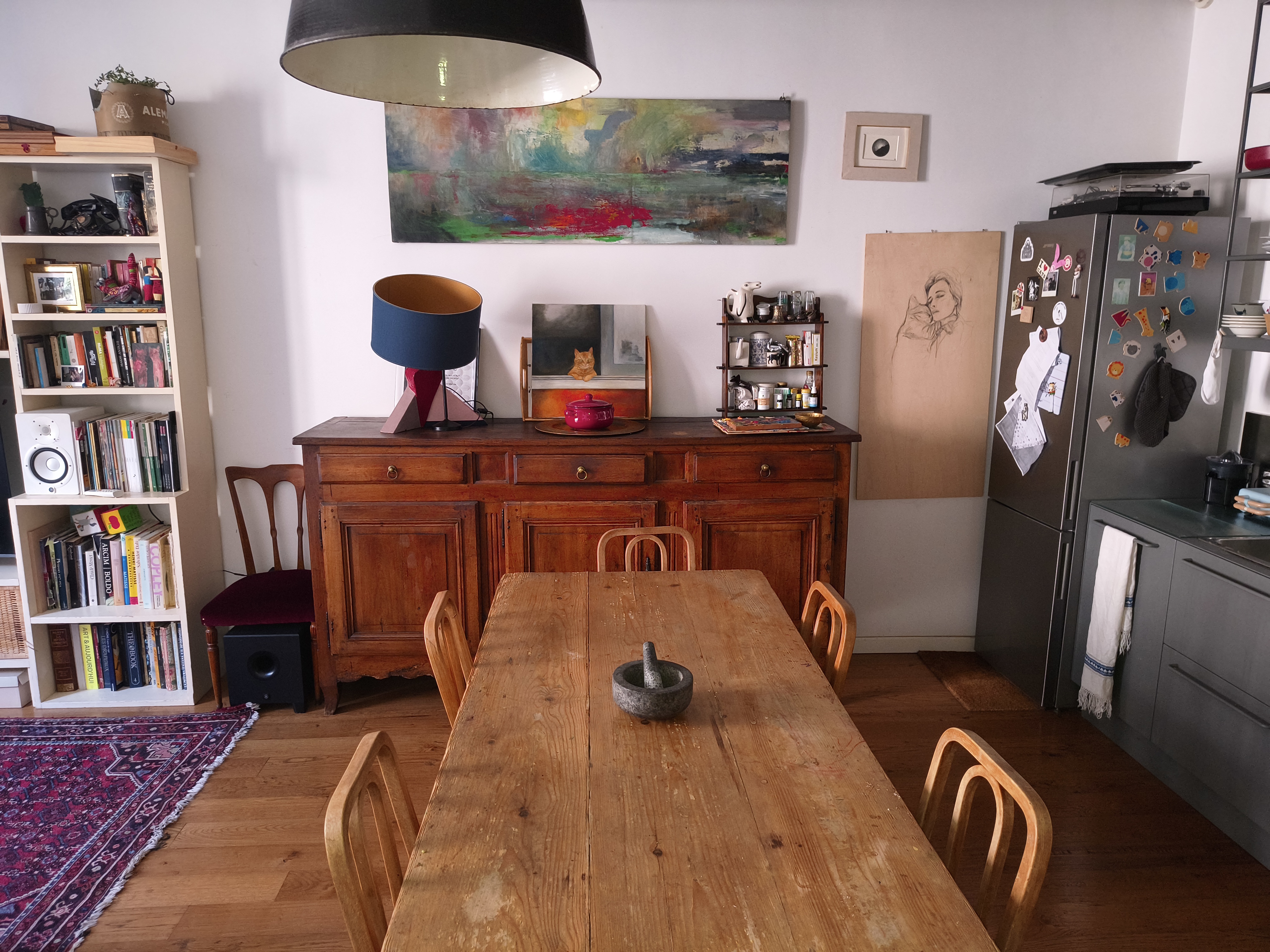 The dining table beneath the wooden beamed ceiling