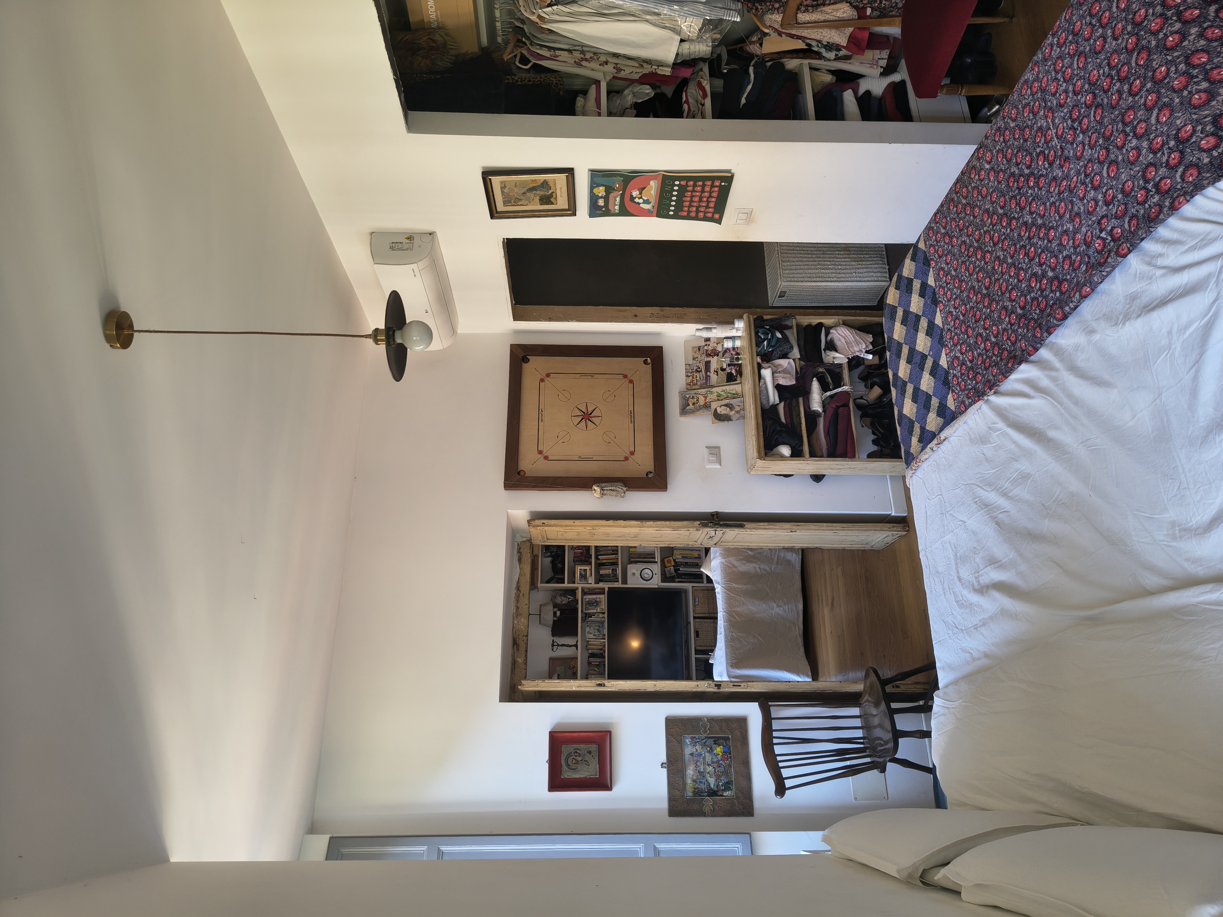 The bedroom with bed and shelves