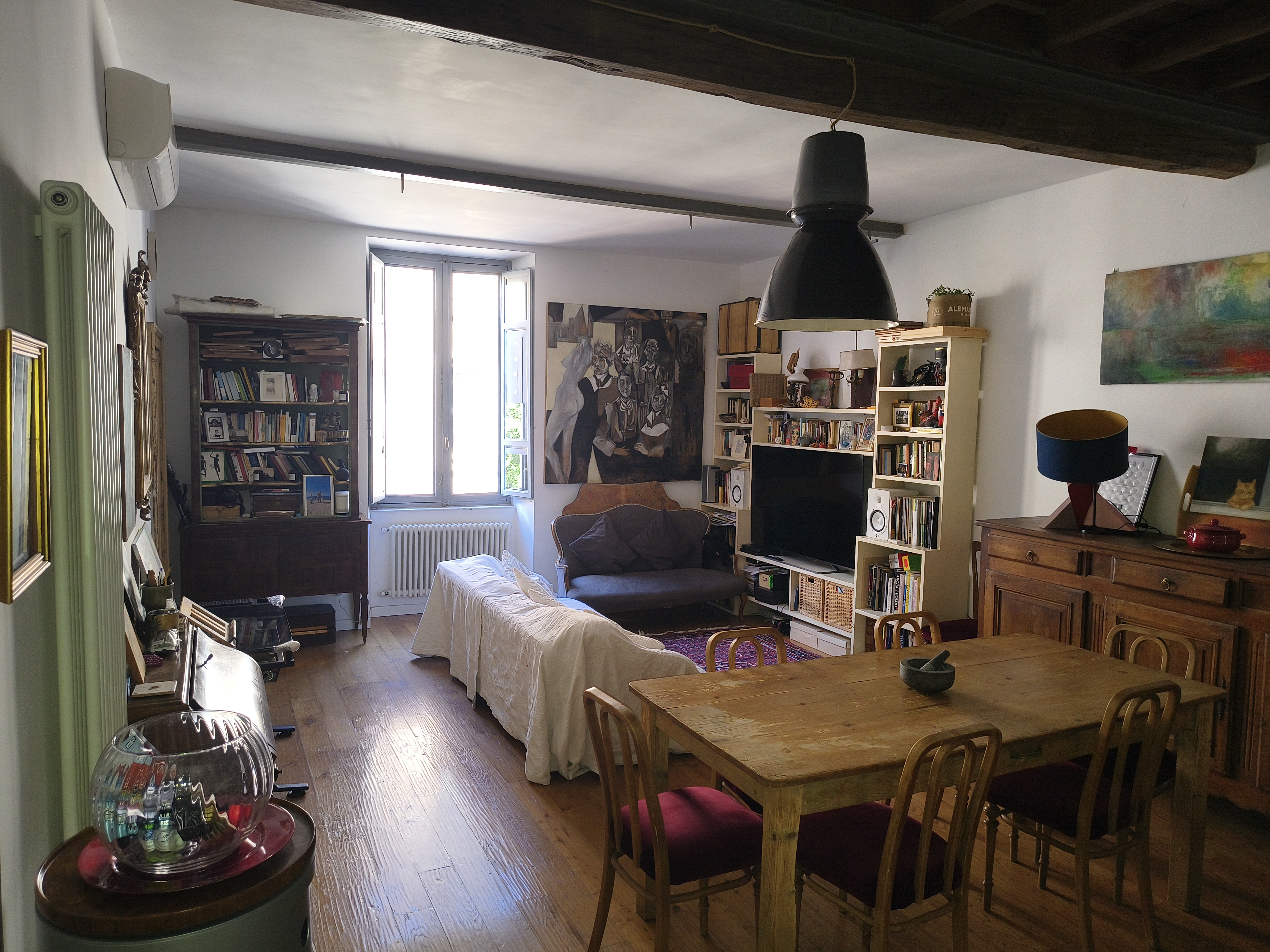 The living room with sofa and dining area