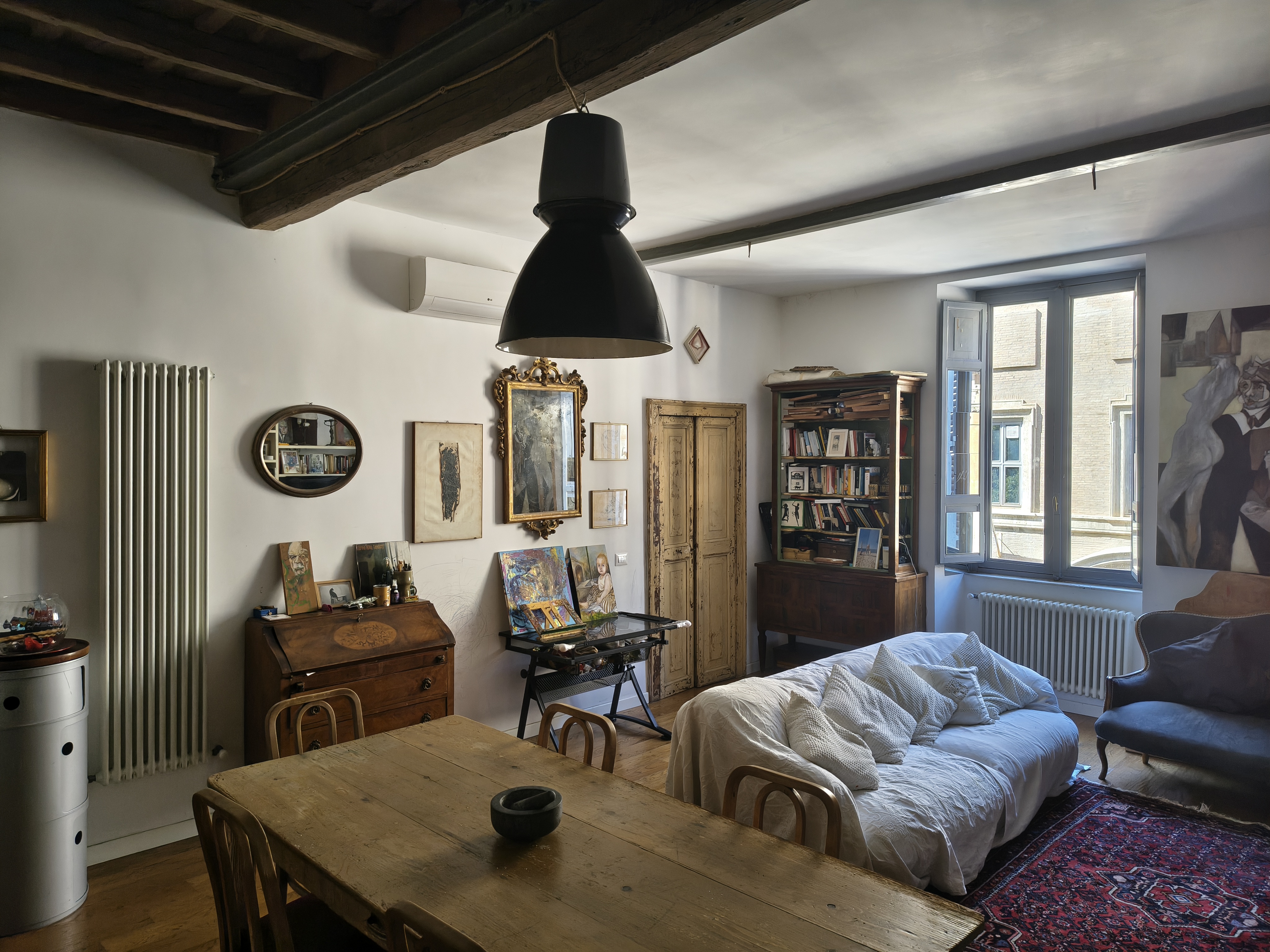 The living room with sofa and antique mirrors