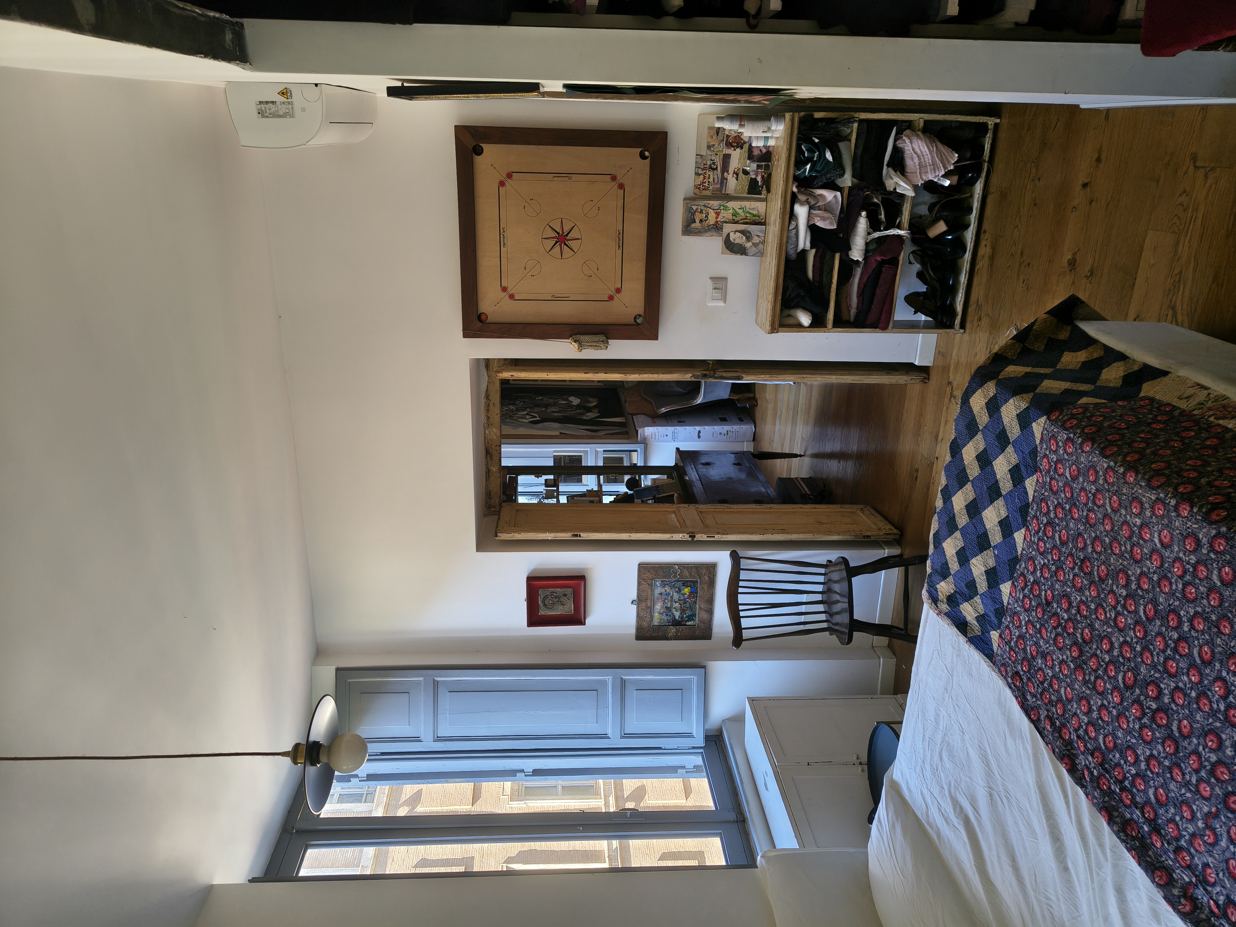 The bedroom with rug and bookcase