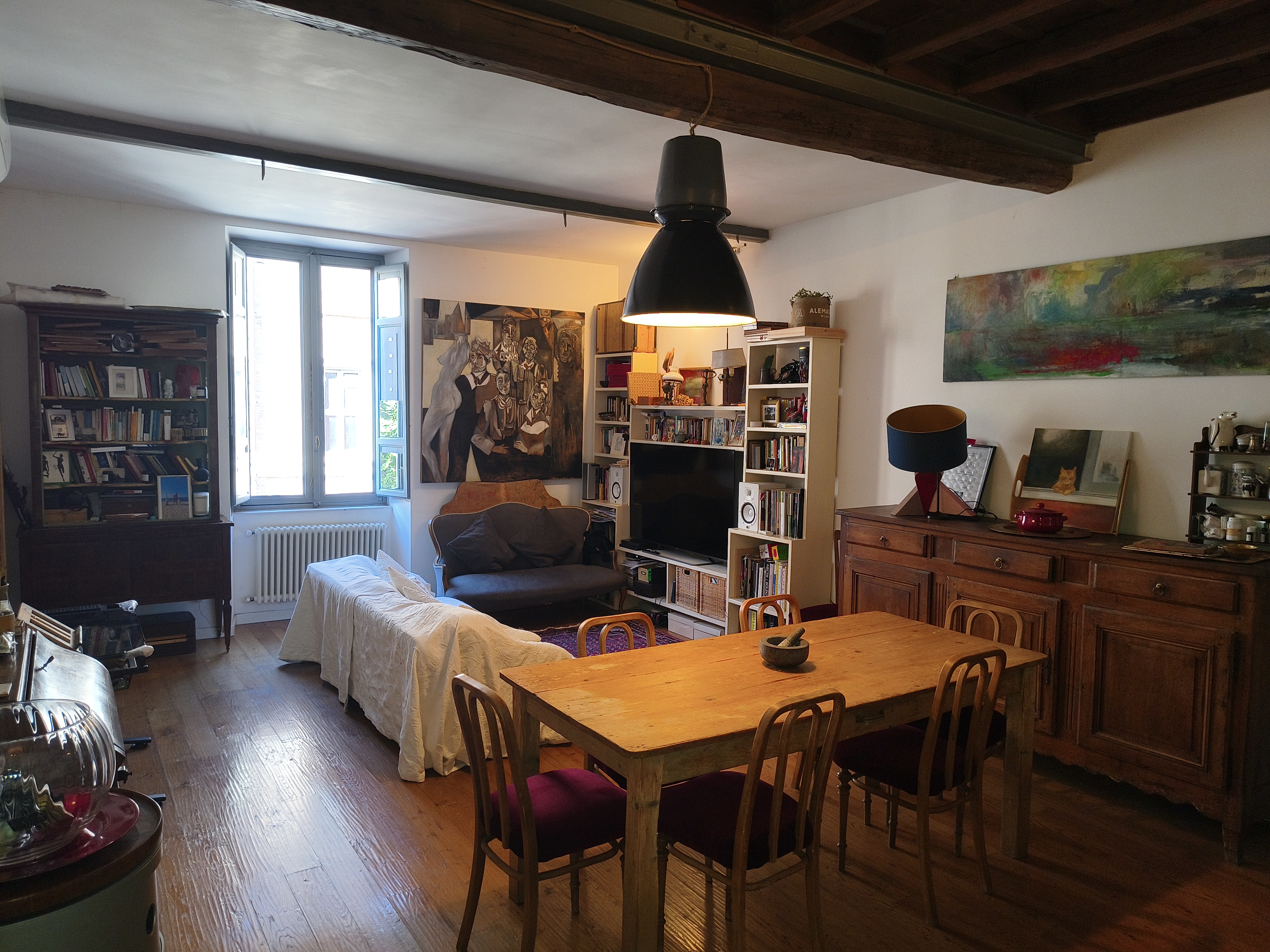 The living room with beamed ceiling