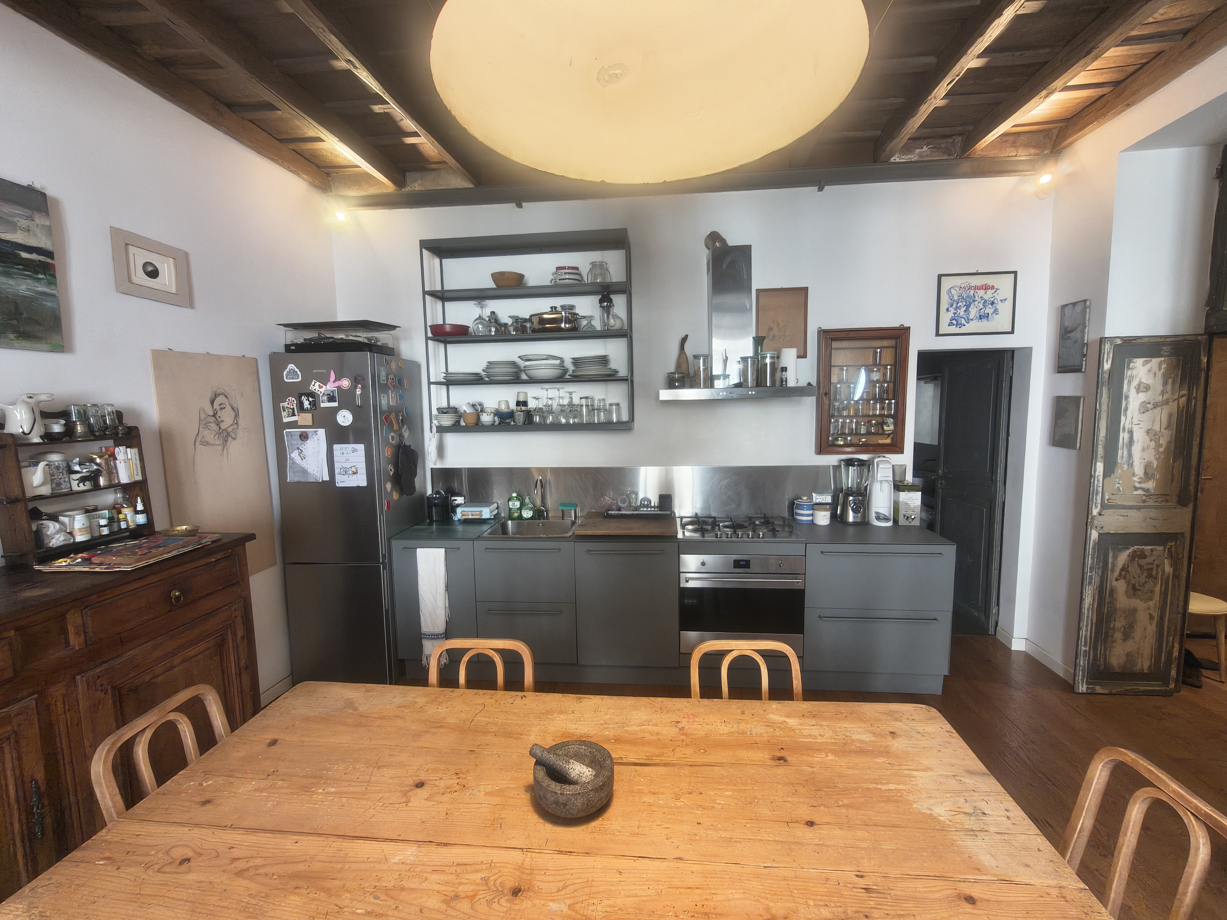 The kitchen with wooden table and exposed beams